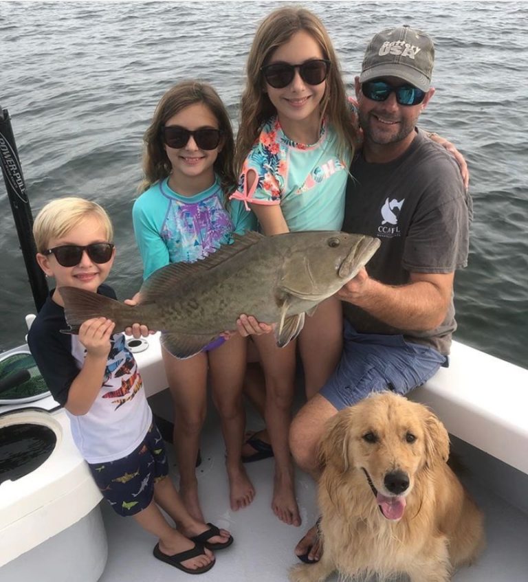 Family show fish one of them caught.