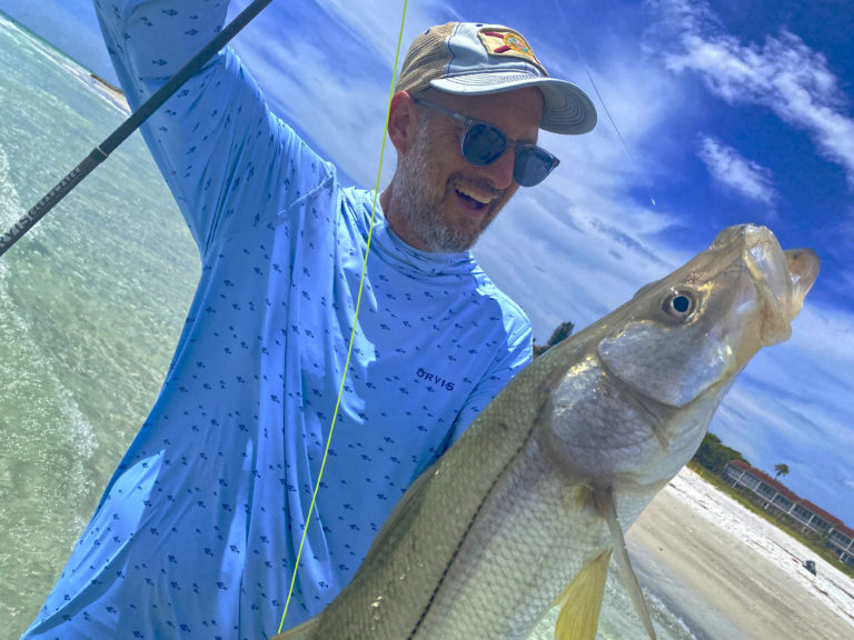 Jason Whitney shows off a snook he caught fly-fishing