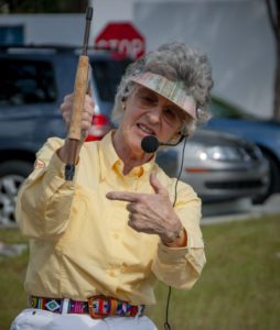 Woman holds fly casting rod.